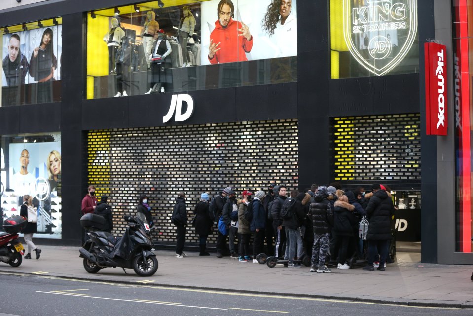 People huddled outside JD Sports in London this morning