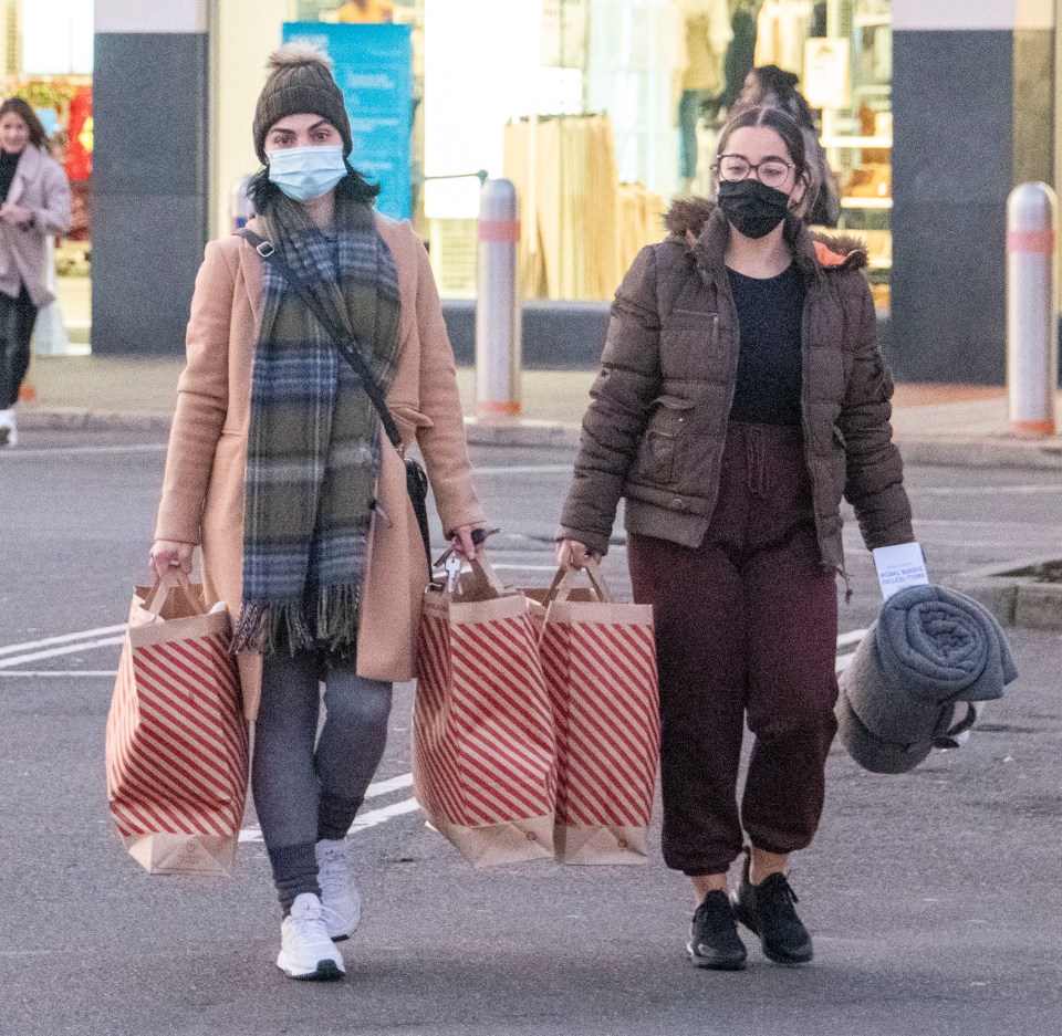 Early bird customers leave with their bargains from Primark at Lakeside, Thurrock before 8am this morning