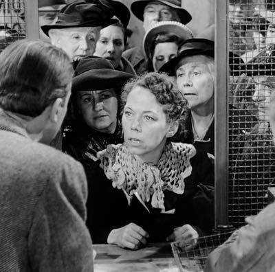 Ellen Corby, centre, opposite James Stewart in It's a Wonderful Life - he leans through the window and surprises her with a kiss when she delivers her line