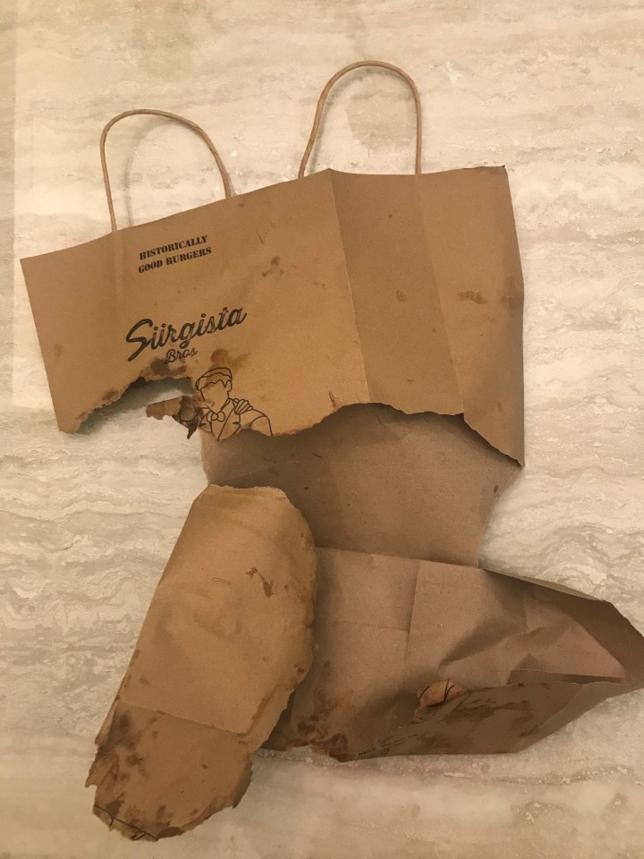 The split paper bag that contained the gourmet burgers