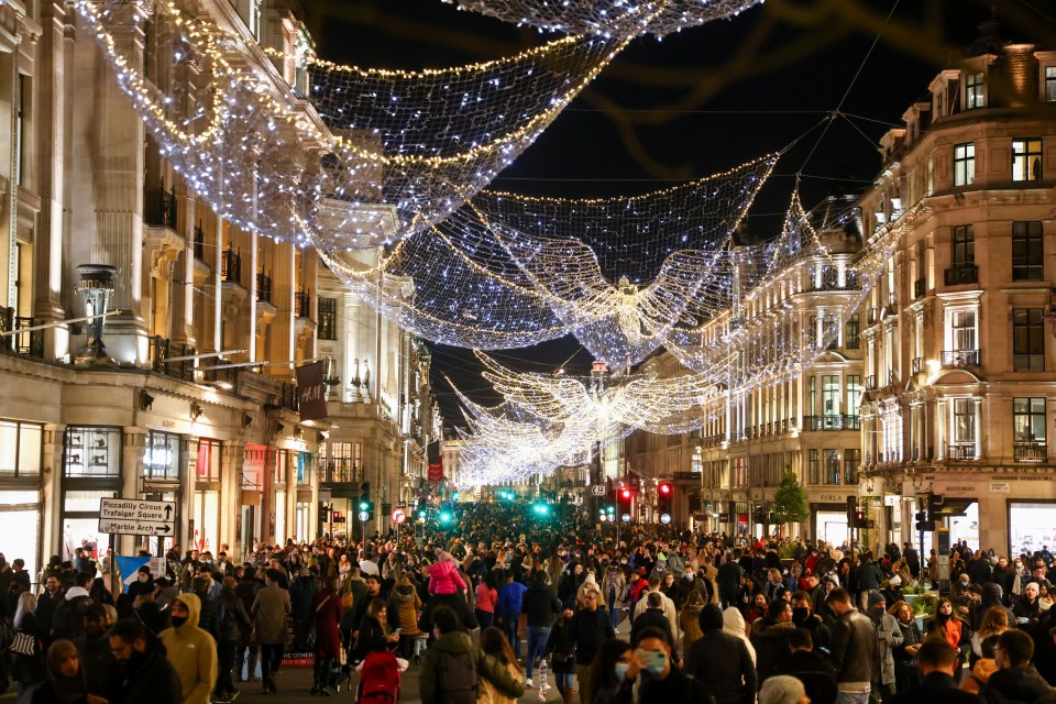 Shoppers walk down pedestrianised Regent Street in London amid the coronavirus outbreak