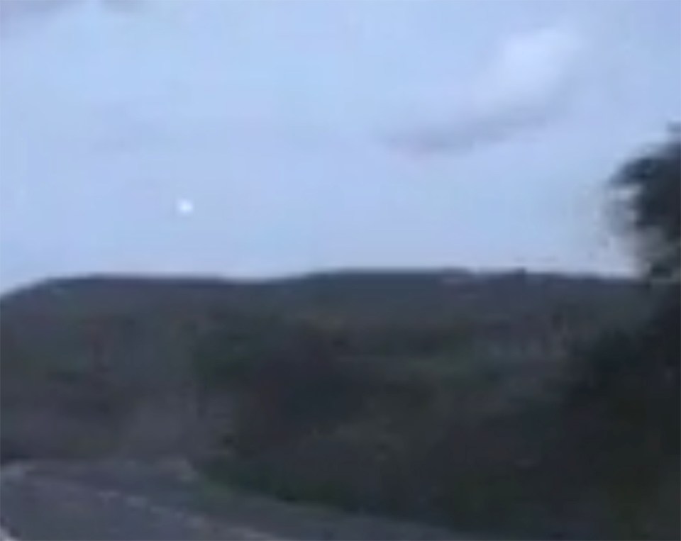 The orb can be seen glowing in the sky above the hill