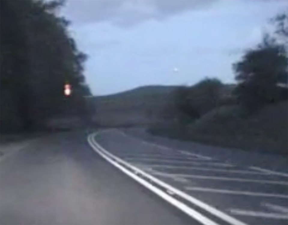 The weird cluster of lights can be seen hovering above the road