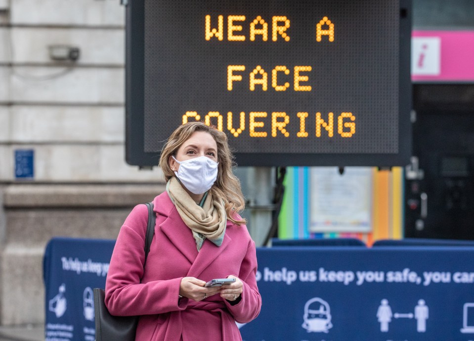 A woman in London wears a face mask