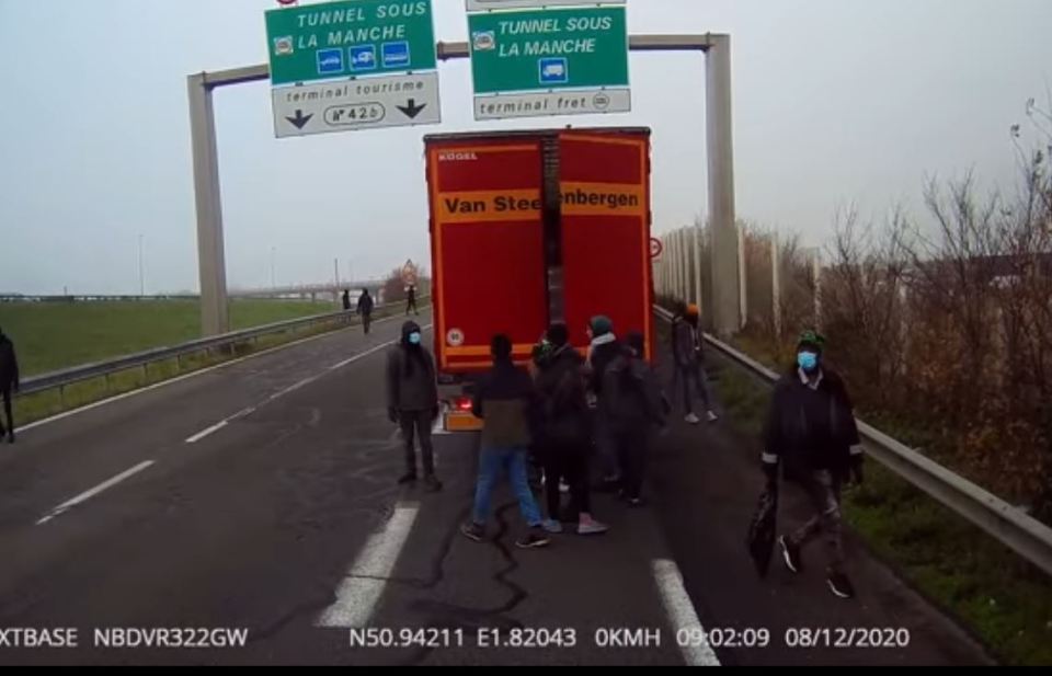 A gang of migrants force open the door of a lorry in Calais this week