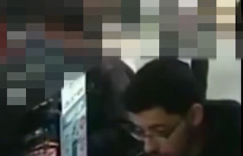 Abedi's face can cleary be seen as he leans down to look at something on the computer screen