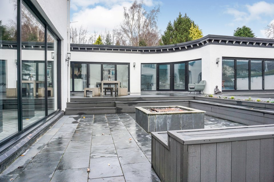 Enormous windows look out to the expansive gardens