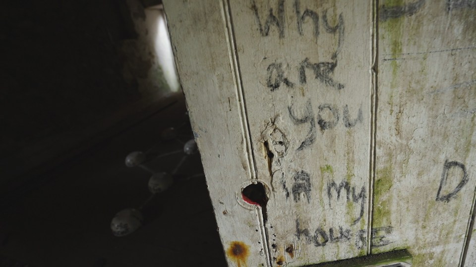 Creepy writing covers the walls of the farmhouse