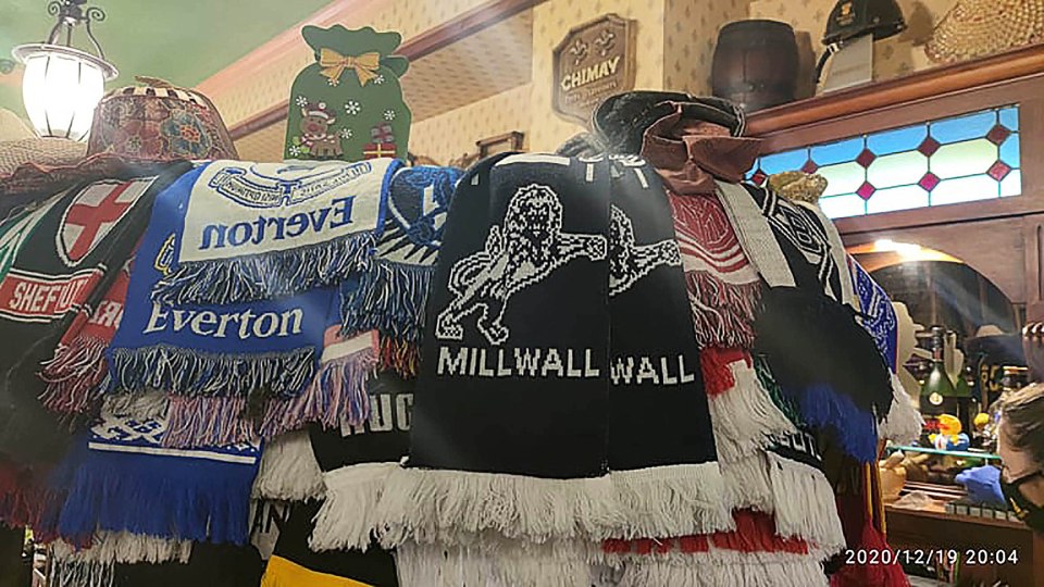 Piles of football scarves at Churchill's Pub - with Millwall at the top