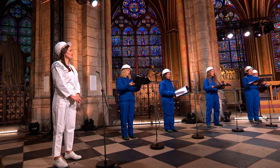 Singers in hard hats and overalls performed a Christmas concert at Notre Dame in Paris