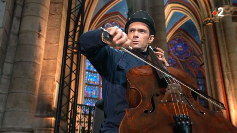 Cellist Gautier Capucon plays despite the cold at the Paris landmark