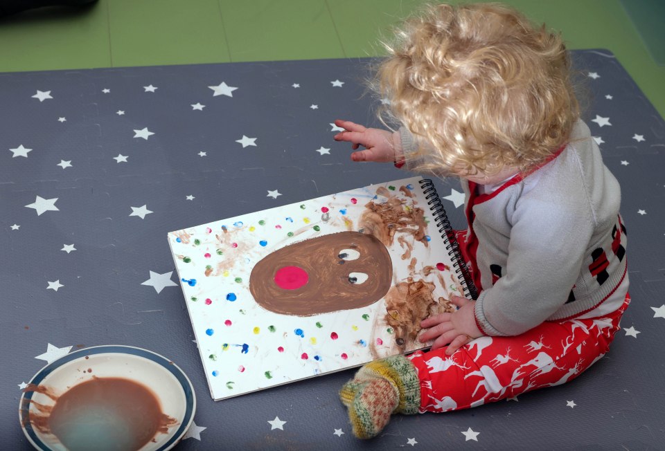 Little Wilfred shows off his painting skills as he adds the finishing touches on to a reindeer