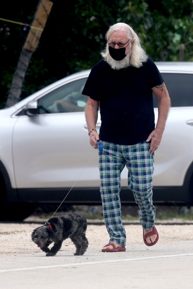 Sir Billy Connolly, 77, looked solemn as he went on a walk with his dog in Key West, Florida