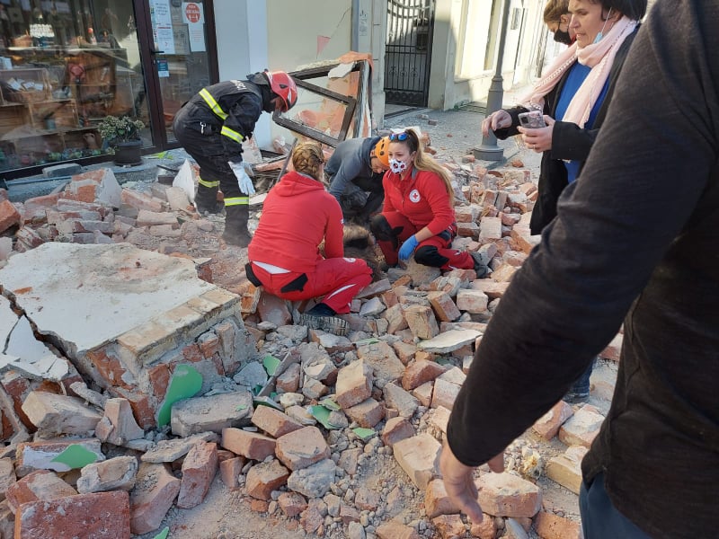 Workers surrounded by rubble