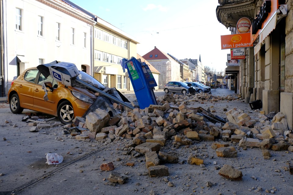 A car seen crushed by rubble