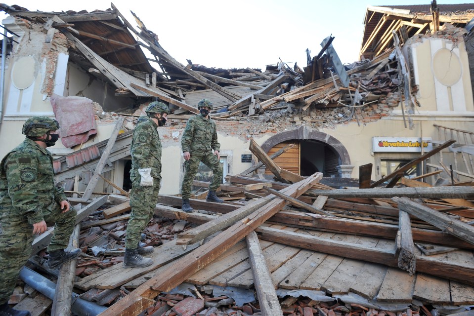 Soldiers inspect the damage to buildings after the earthquake