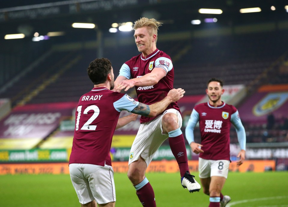 The Clarets mob Ben Mee after his goal helped lift them away from trouble