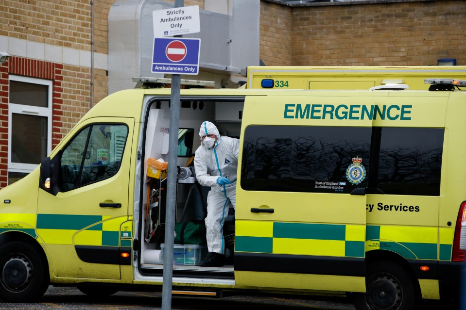 A healthcare worker wearing PPE gets out of the ambulance outside Southend University Hospital as the crisis in hospitals deepens