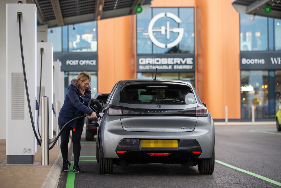 A driver plugs in a charger during the trial