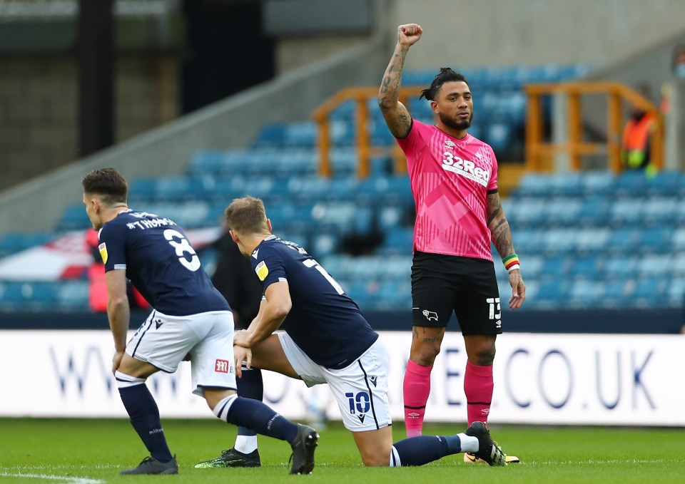 Millwall players take a knee before kick-off against Derby