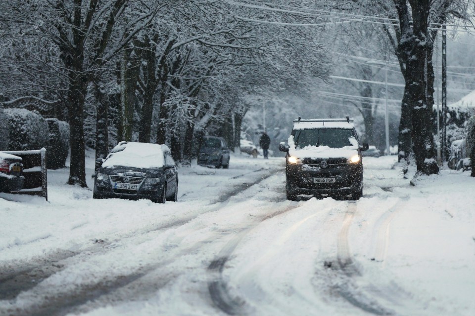 A van attempts to make it down a snow-covered road in Stourbridge