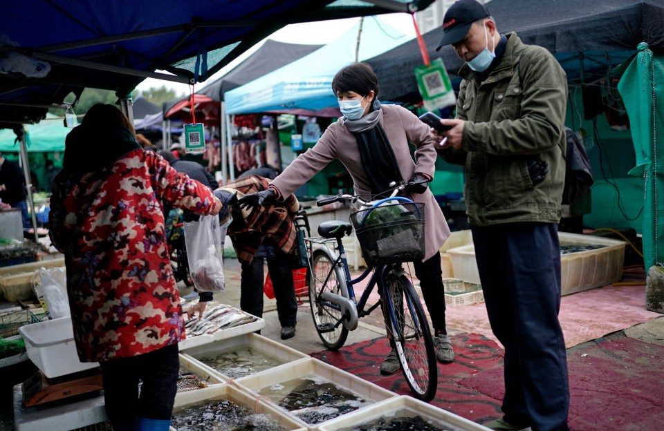 Locals buy fresh fish from the market in Wuhan