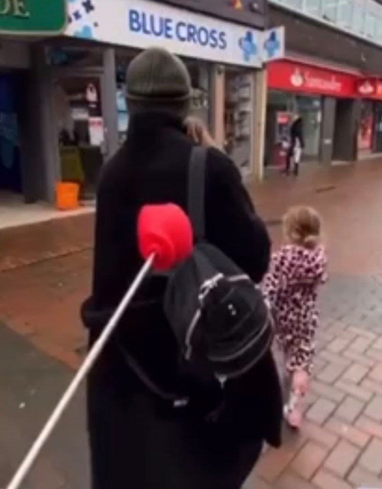 Kelvin also prodded Liz with the novelty boxing glove on a stick as they walked down a street