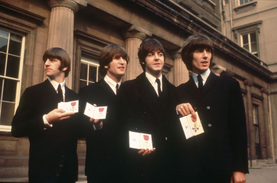 The Beatles - Ringo Starr, John Lennon, Paul McCartney and George Harrison - show their MBE awards in 1965