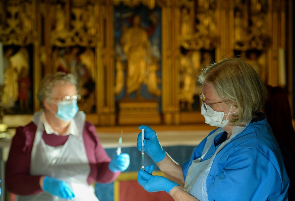 Staff prepare to give the Pfizer Covid vaccine to patients at the vaccination centre set up inside Salisbury Cathedral on January 20