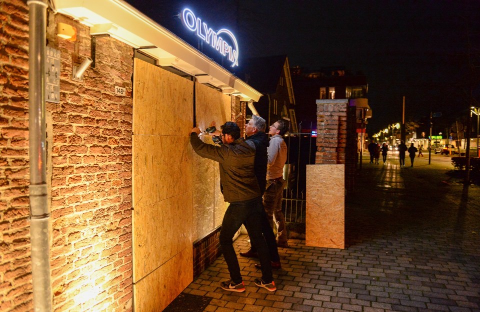 Shop owners are seen barricading the windows of their businesses on January 26, 2021 in Schijndel, Netherlands to avoid possible looting