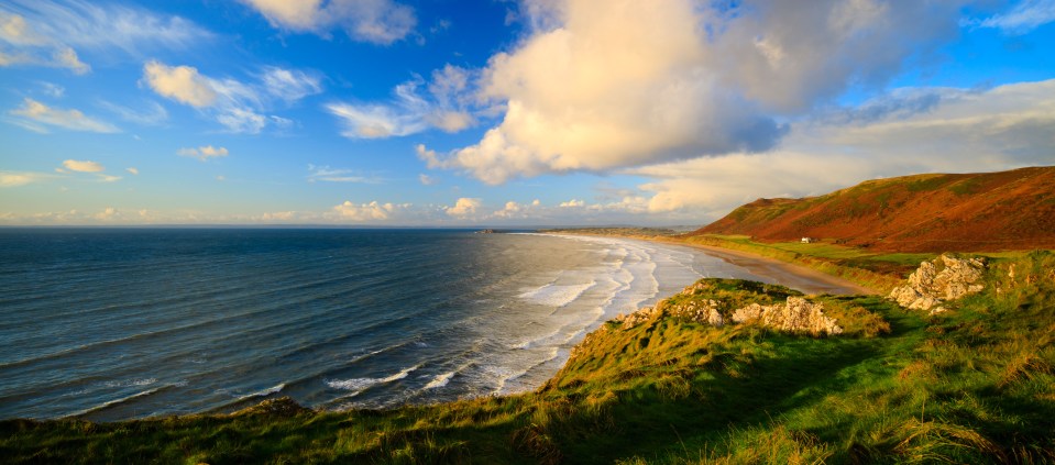 Head to this beach near Swansea for miles of sandy coastline