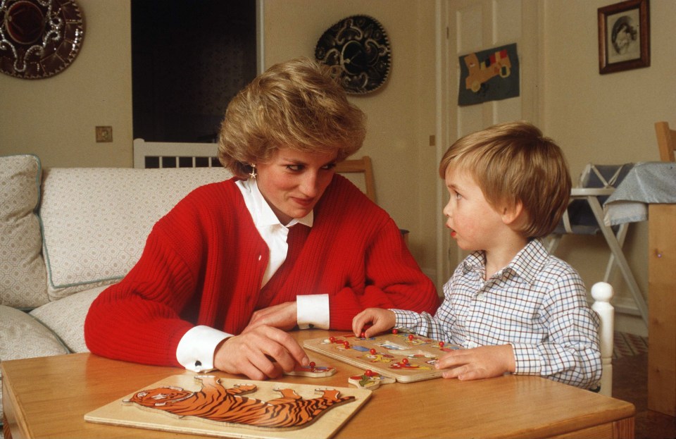 Diana, Princess of Wales helping a young Prince William with a jigsaw puzzle in his playroom 