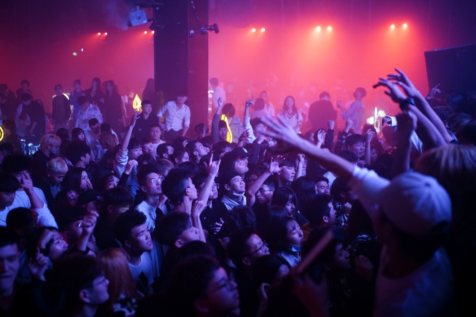 People dance in a crammed a nightclub in Wuhan on December 12