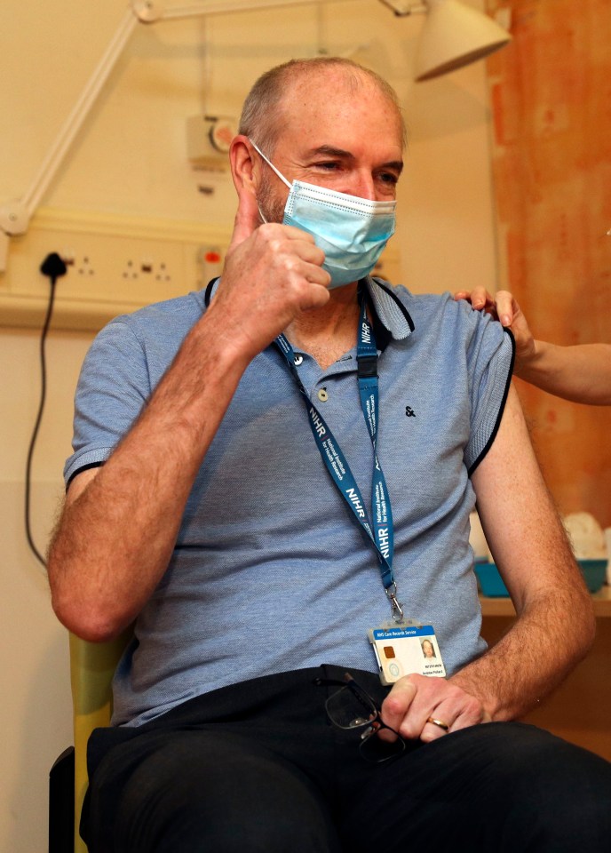 Professor Andrew Pollard, Director of the Oxford Vaccine Group, gives the thumbs up as he receives the jab