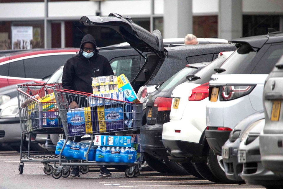 Shoppers unpacking full trolleys at Costco in Chingford, London