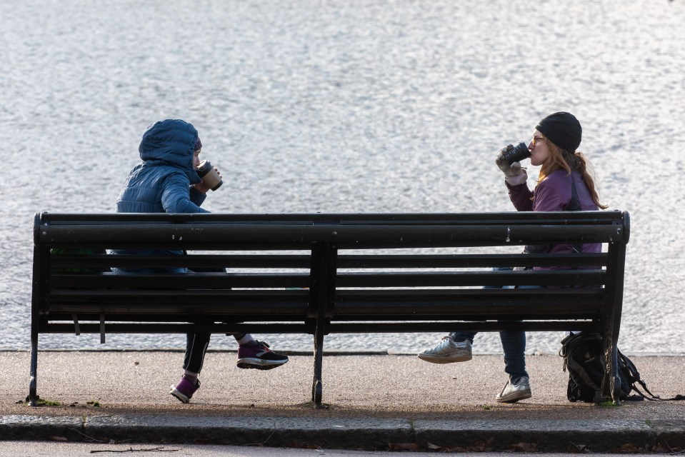 Two people enjoyed a coffee while out for a walk in the park