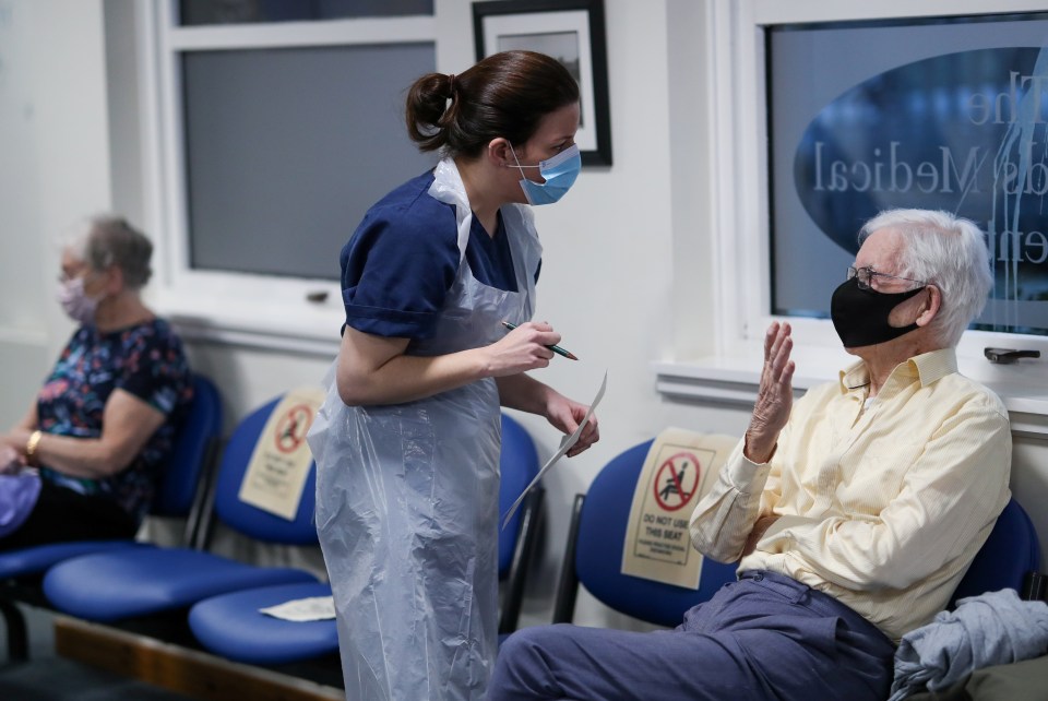 Elderly people invited for their Covid jab wait to be vaccinated at a GP surgery in Currie, Scotland, today