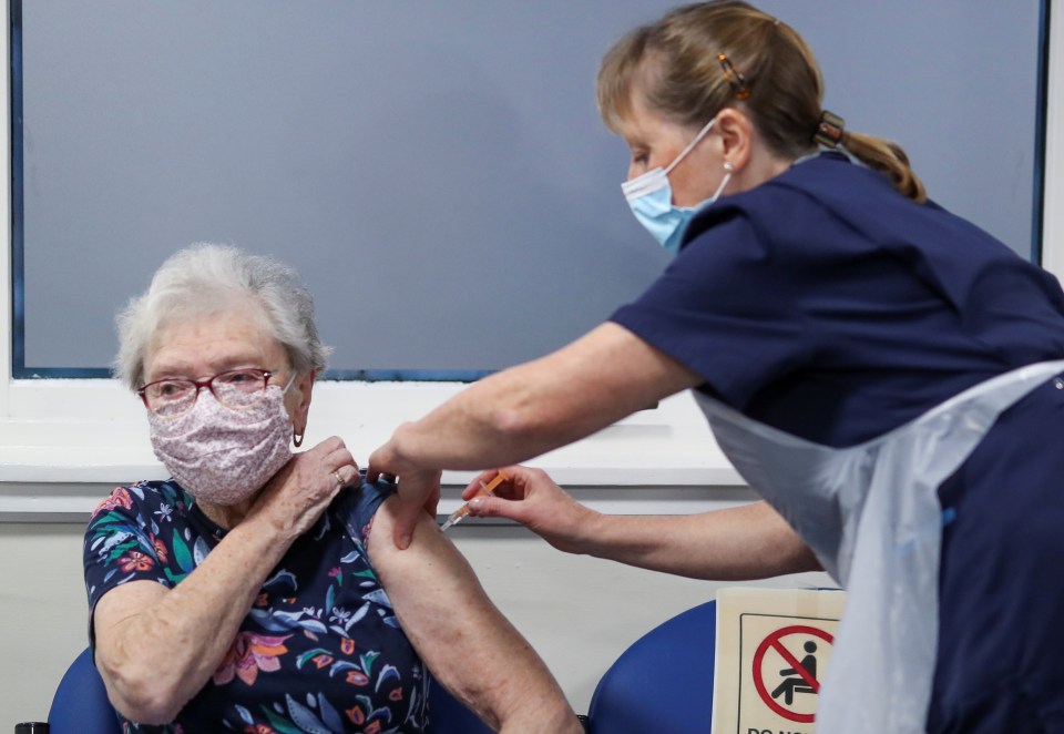 A woman receives a dose of he Oxford/AstraZeneca vaccine at the Pentland Medical Practice, in Currie, Scotland