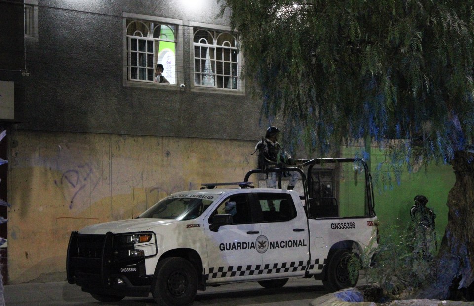 Members of the National Guard patrol the bloody crime scene