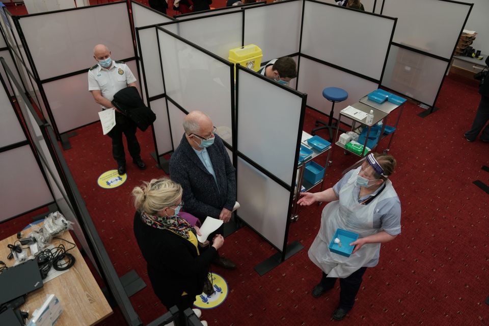 People wait to receive their Covid-19 vaccine at the NHS vaccine centre that has been set up at the Centre for Life in Times Square, Newcastle