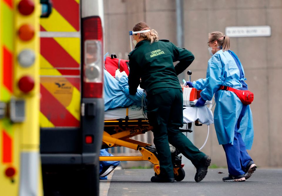 A patient is taken from an ambulance by staff wearing PPE equipment at the Royal Free Hospital in London on January 11