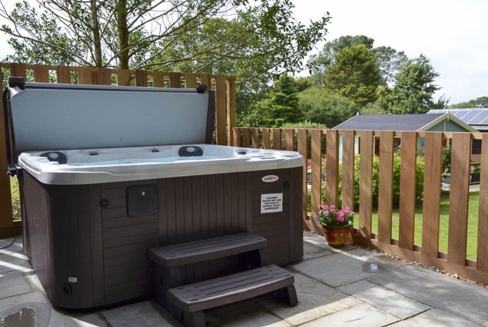 A large landscaped garden provides the perfect backdrop for a dip in the hot tub