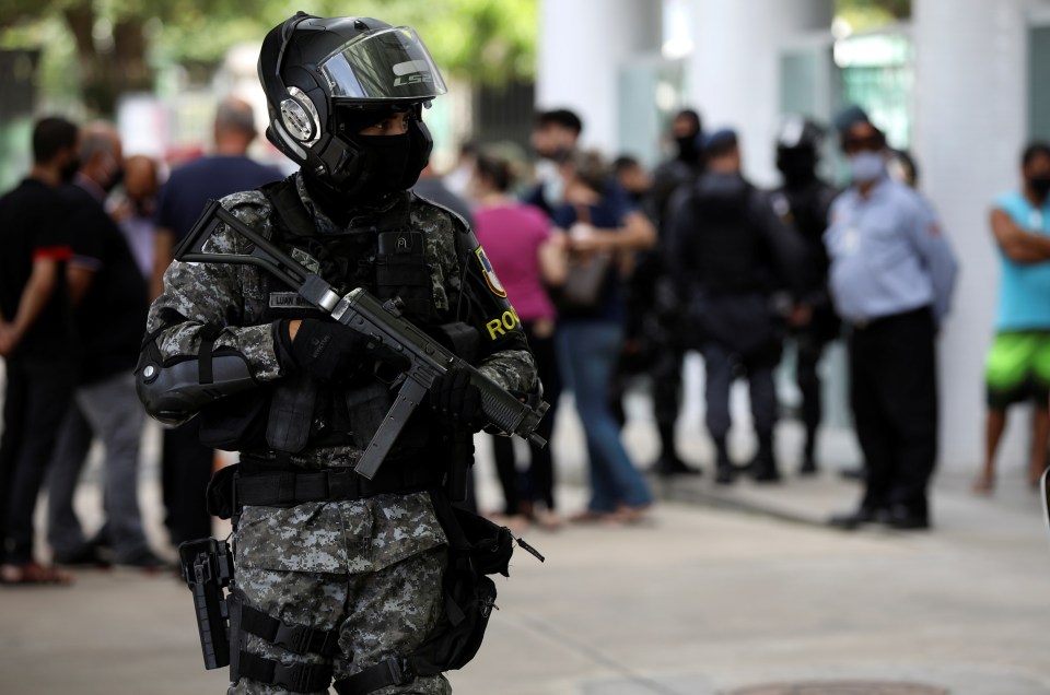 A police officer patrols at Getulio Vargas hospital as medical services are pushed to breaking point in Brazil