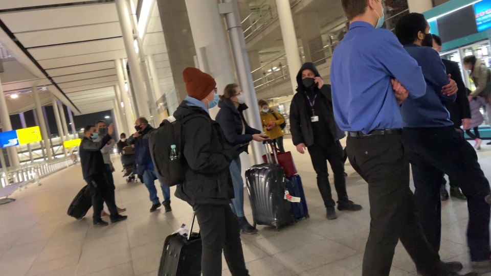 Confused passengers look around as they are being evacuated 