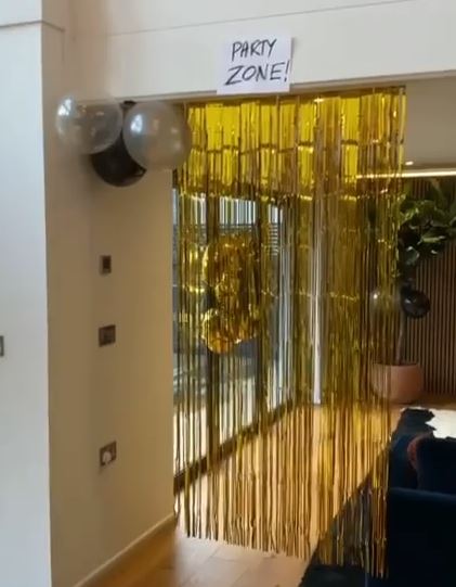 Joel created a specific 'party zone' framed with gold streamers