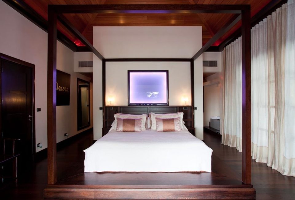 The master bedrooms feature a four-poster bed with dark furnishings