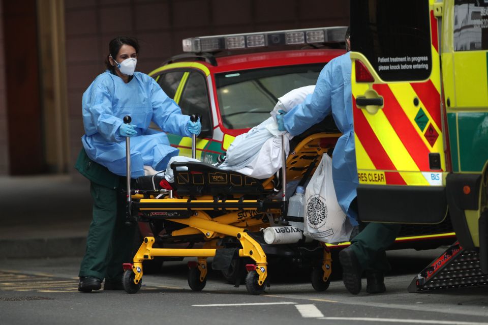 Paramedics transport a patient outside the Royal London Hospital in London