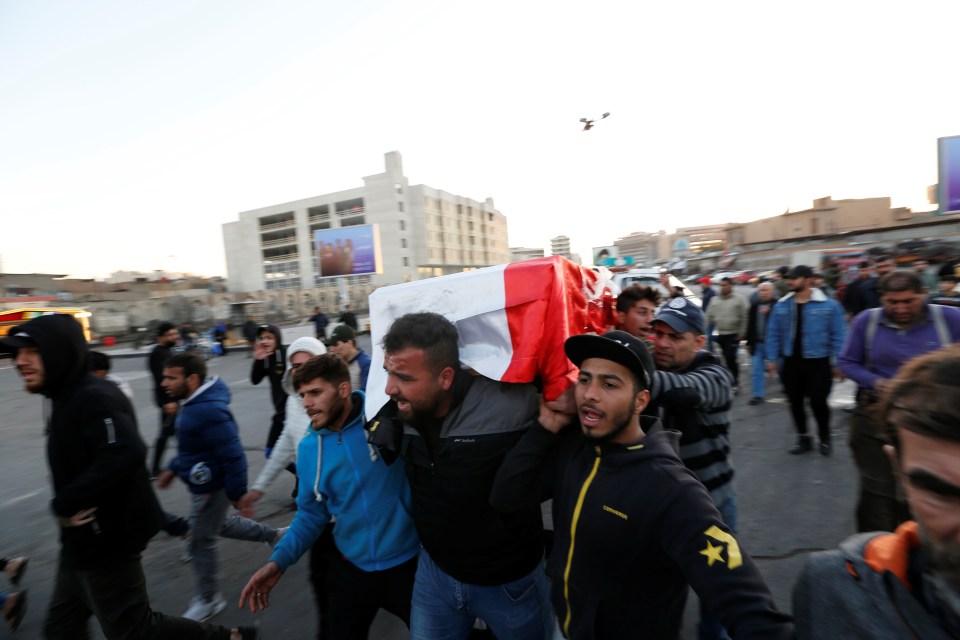 Mourners carry the coffin of a victim of the bombings through the city