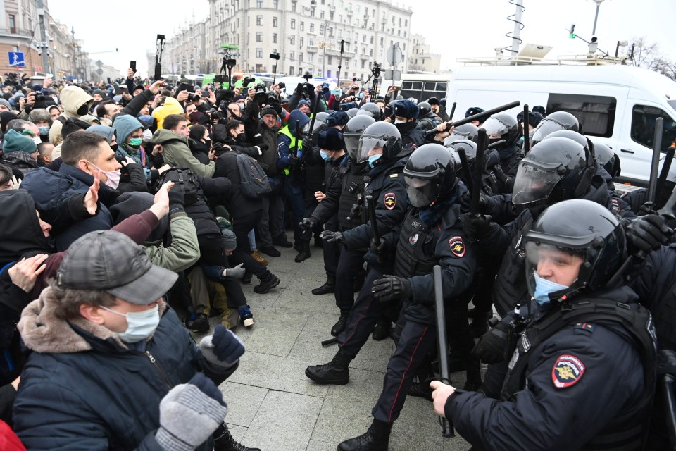 Protesters are seen facing off against a line of armour-clad police