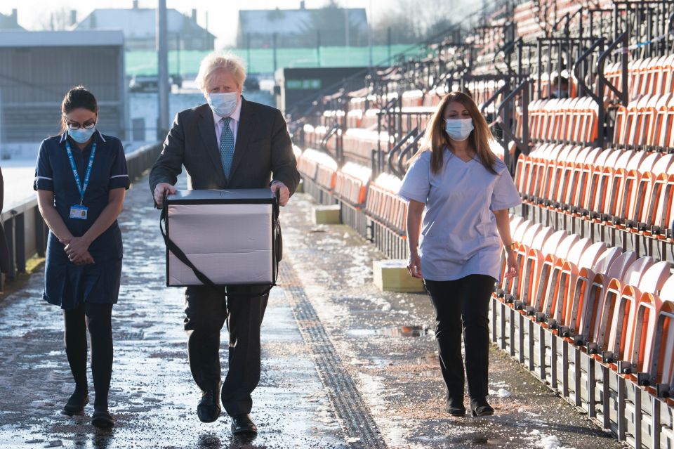 Prime Minister Boris Johnson loads doses of the Oxford/Astrazeneca coronavirus vaccine for mobile distribution at Barnet FC's ground, The Hive, north London